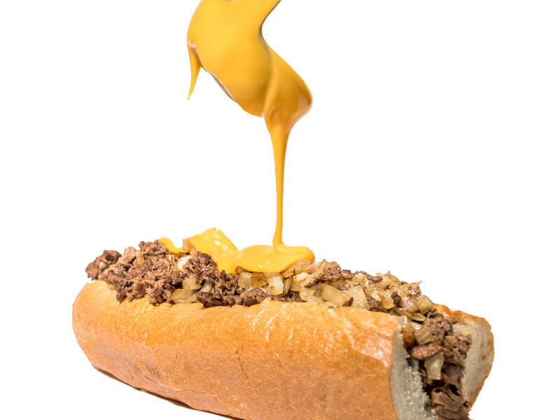 Pouring Whiz Over Cheesesteak Pouring Whiz Over Cheesesteak